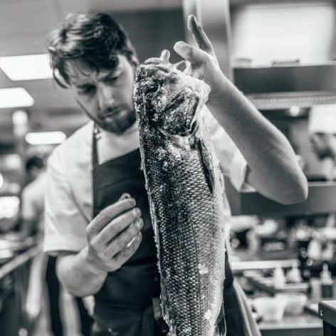 Alex Parker, Head Chef at the Rose & Crown in Essendon, holding up a large fish